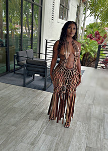 Woman in a macrame, crochet dress swim cover in bronze